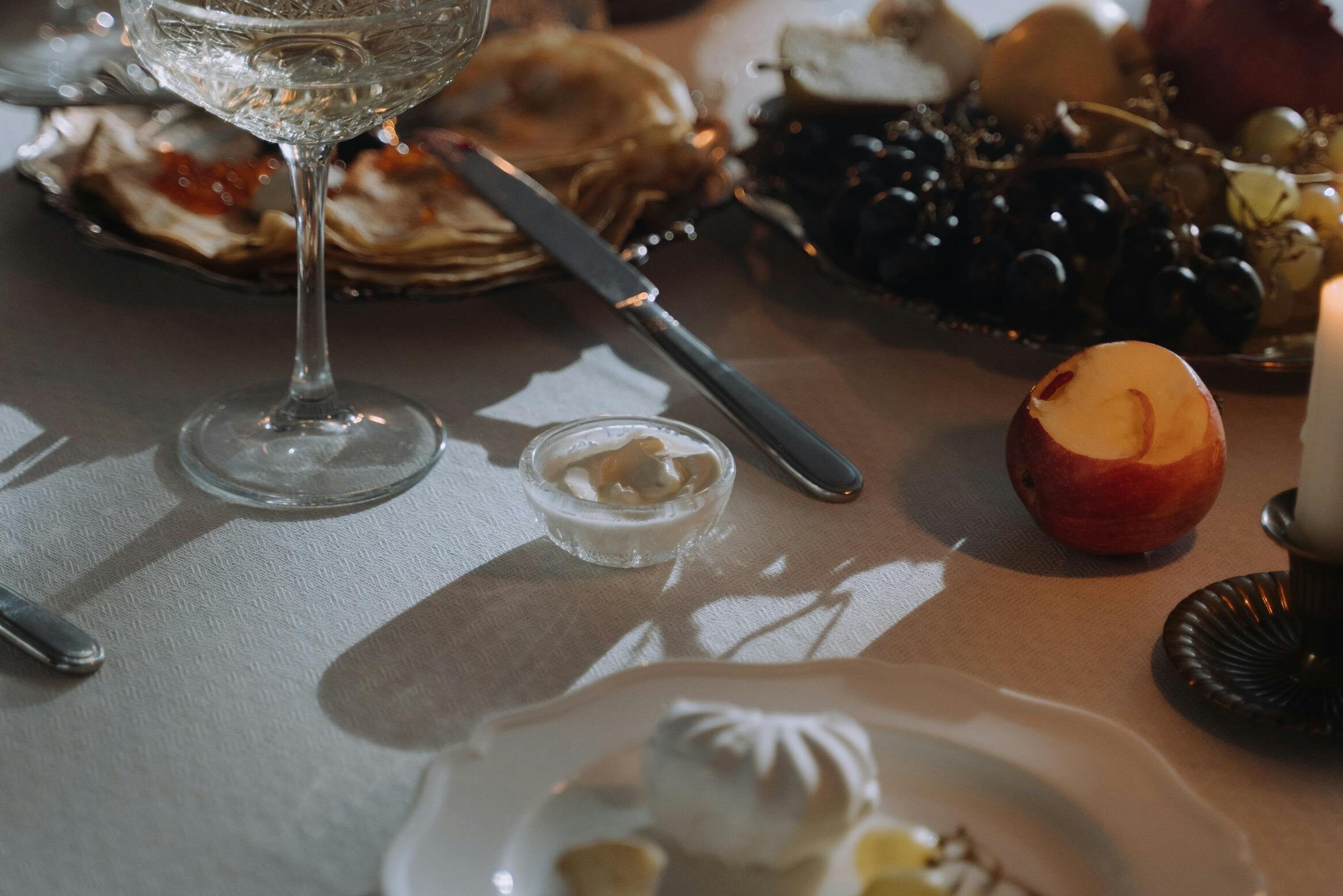 white wine and cheese board at a table 