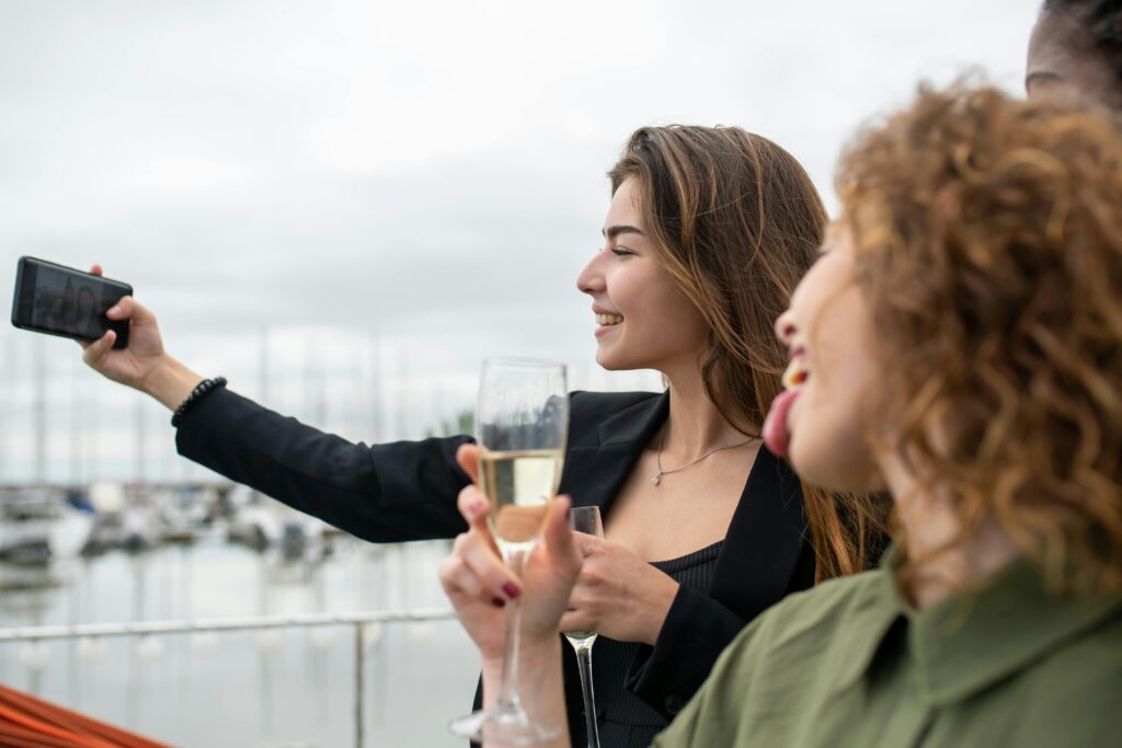 girls taking a selfie while drinking champagne 