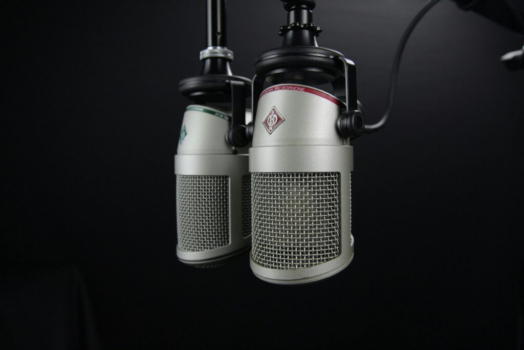 picture of microphones hanging from the ceiling for a podcast