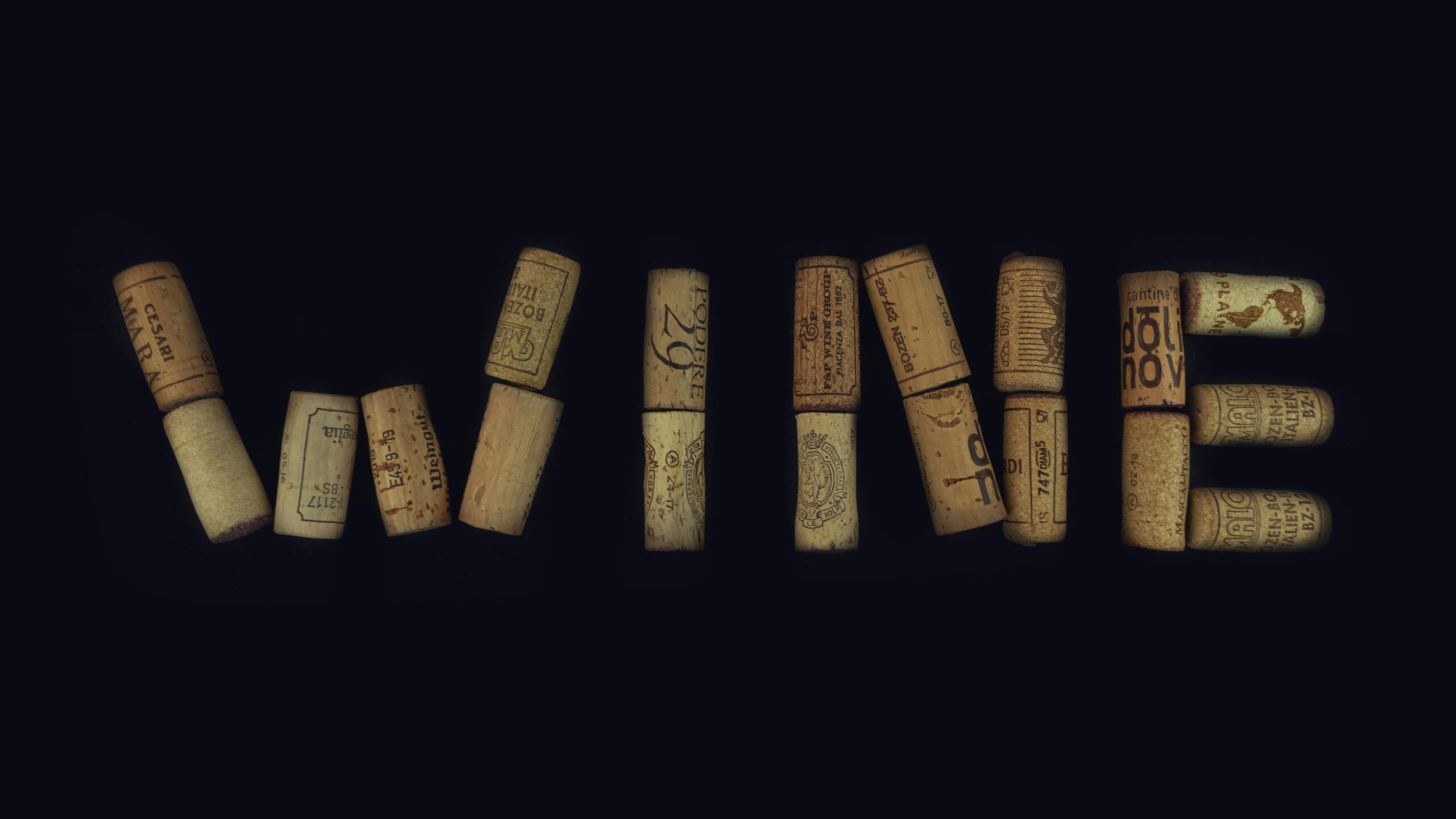wine corks laid out to spell the word "wine"